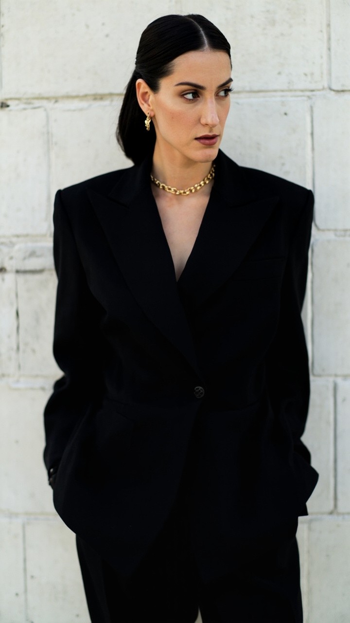 A Luxury Minimalist Outfit Against White Wall