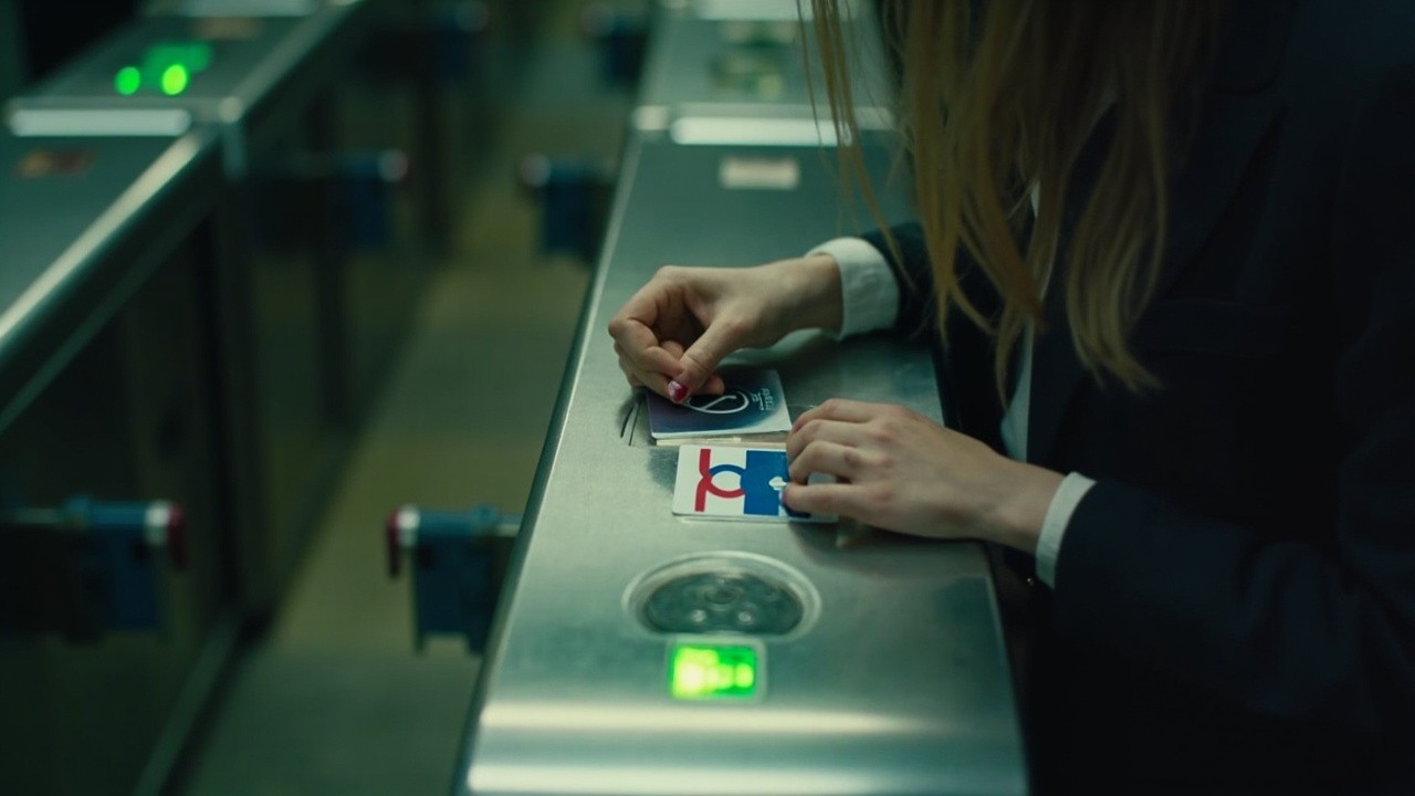 Hand Swiping London Metro Card at Turnstile