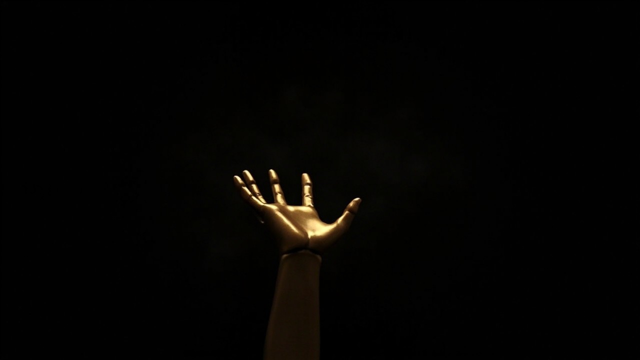 The Golden Hand in a Black Background