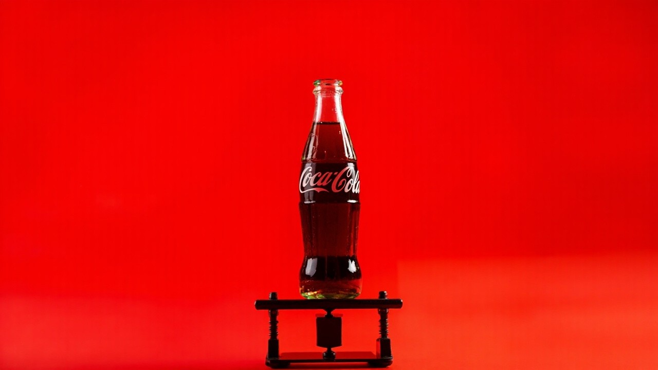 The Mini Lift Uplifting a Coca-Cola Bottle