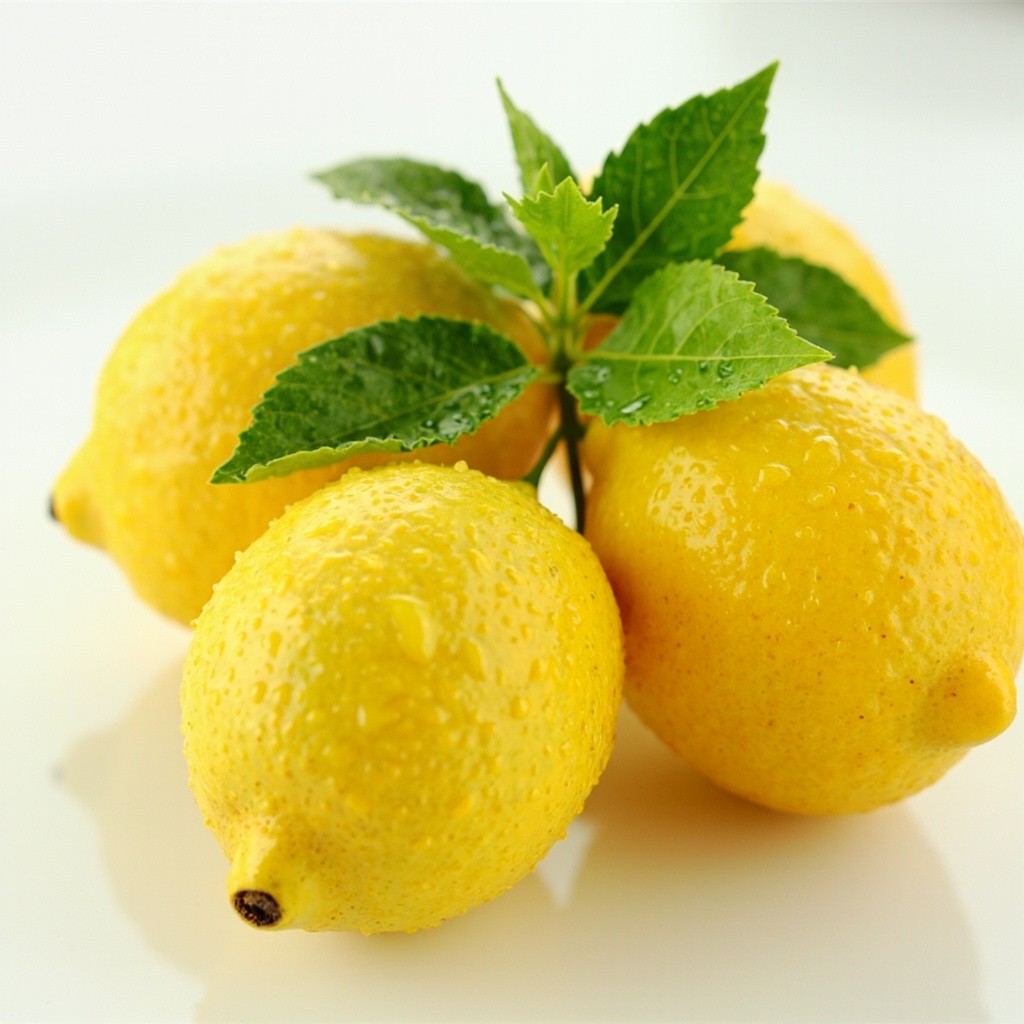 Three Fresh Lemons on Glossy White Surface